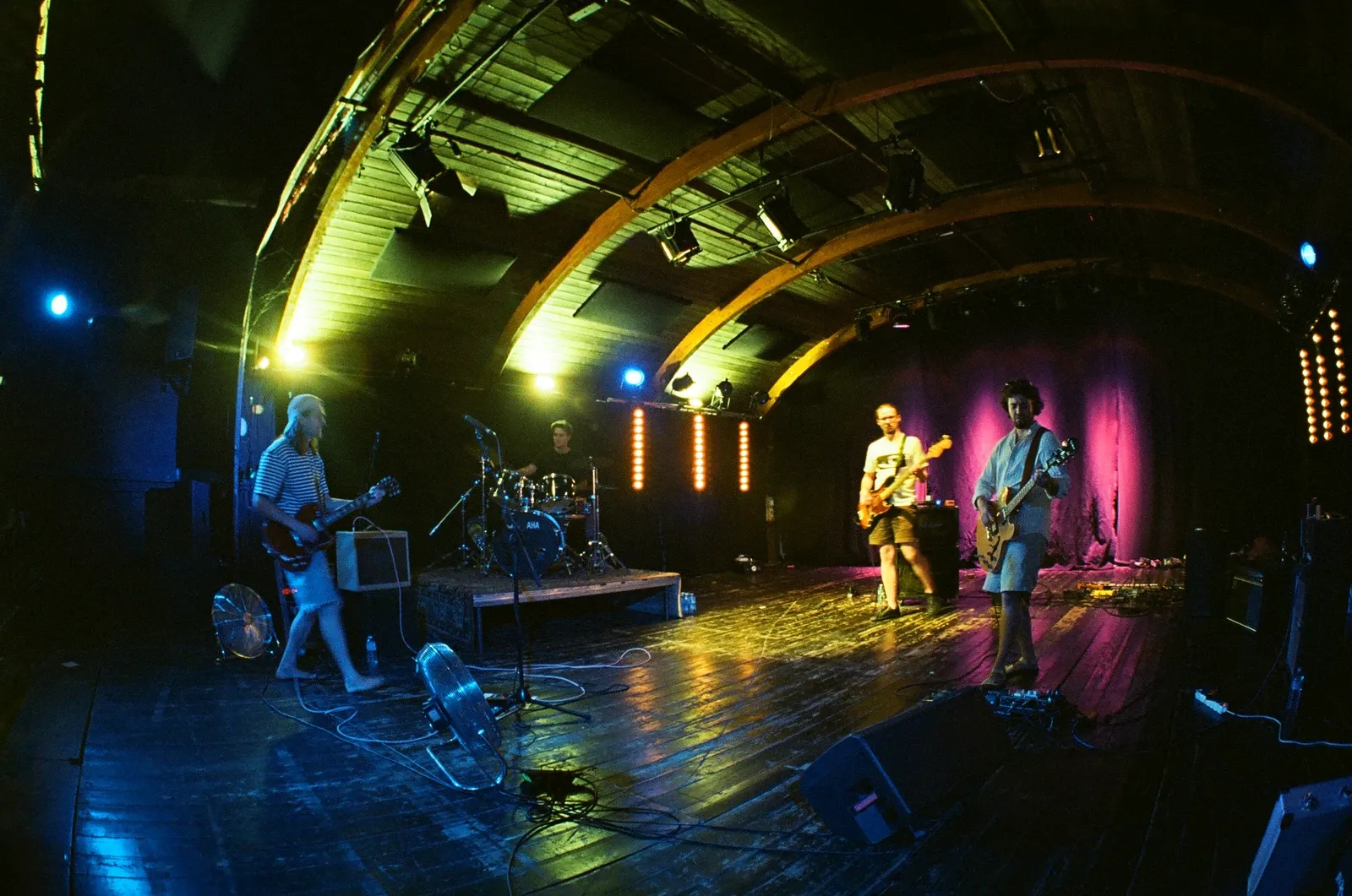 Hannetones playing live on the boat stage at Loď Tajemství, Prague, under blue, yellow and pink stage lights